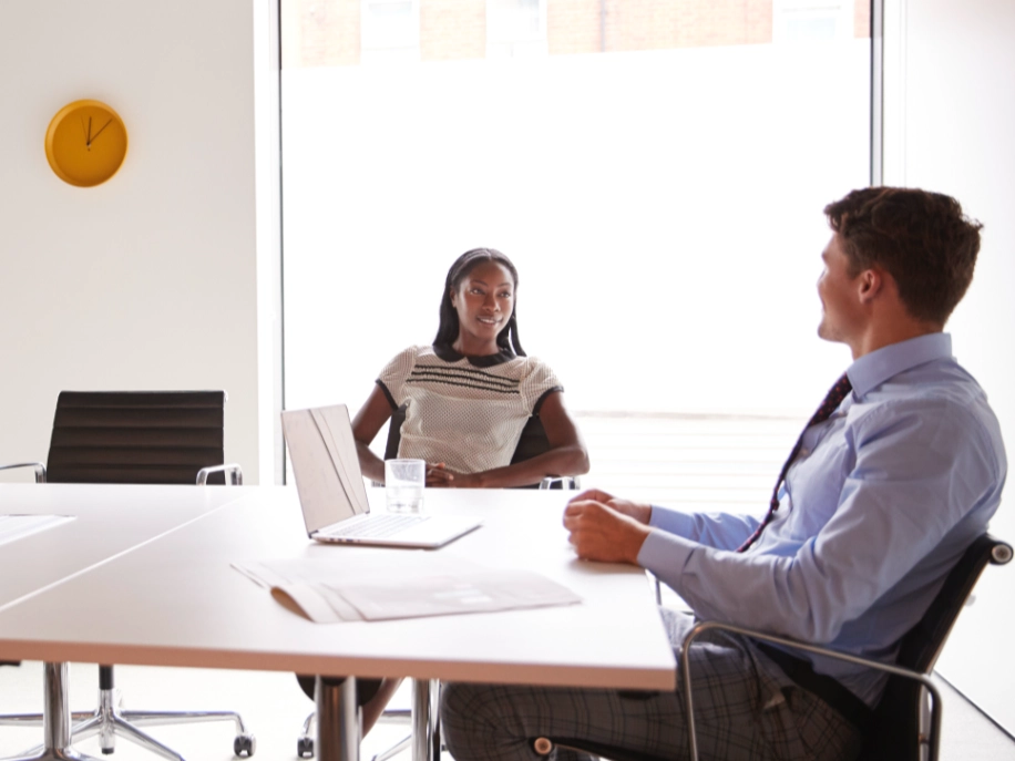 Meeting between two colleagues at an office setting